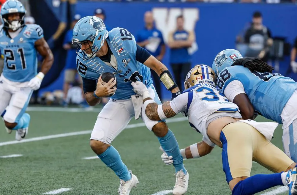 John Woods / THE CANADIAN PRESS Blue Bombers linebacker Tony Jones pulls down Toronto Argonauts quarterback Chad Kelly in Winnipeg on Friday.