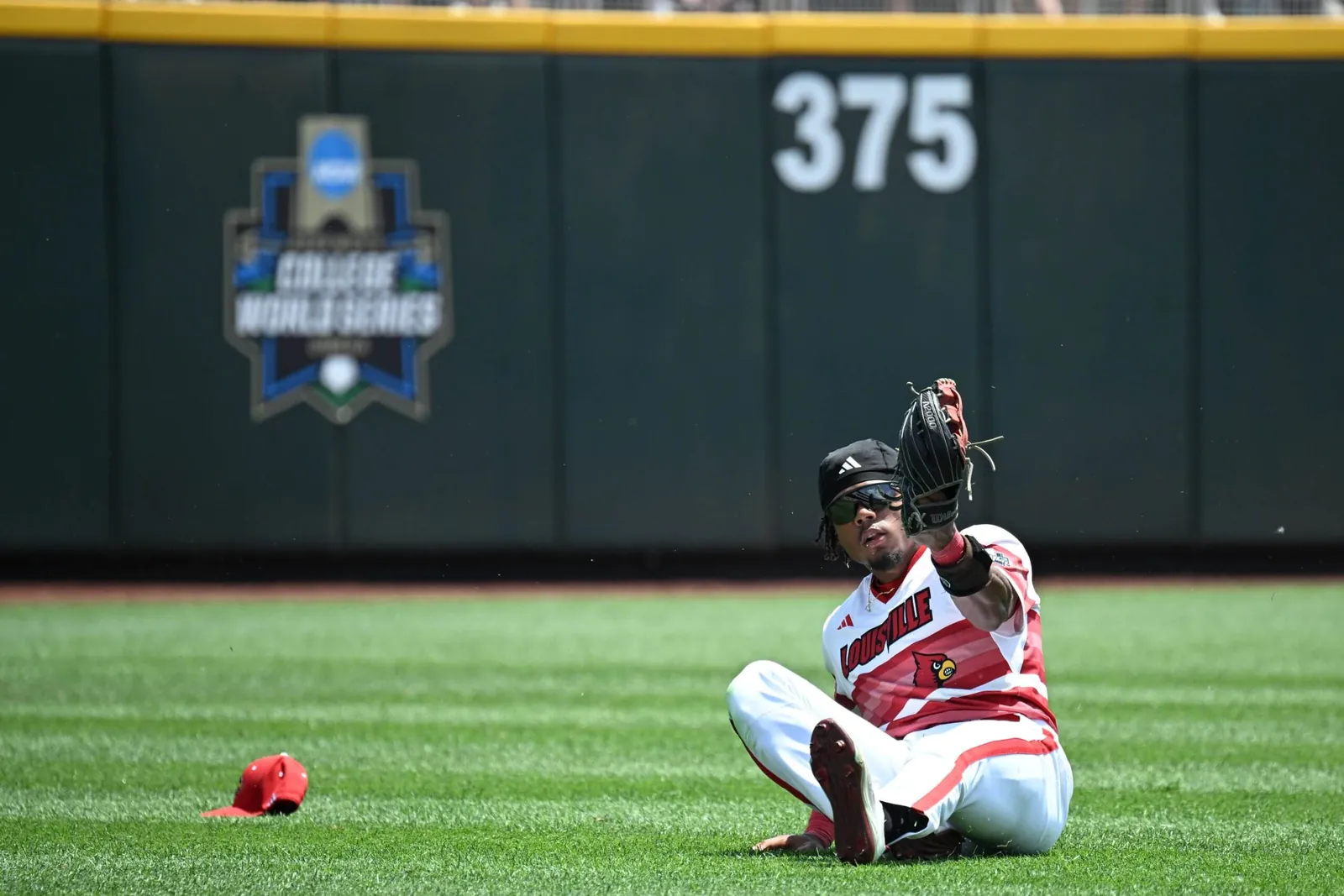 Louisville Cardinals left fielder Zion Rose (32) makes a sliding play against the Arizona Wildcats during the second inning at Charles Schwab Field.